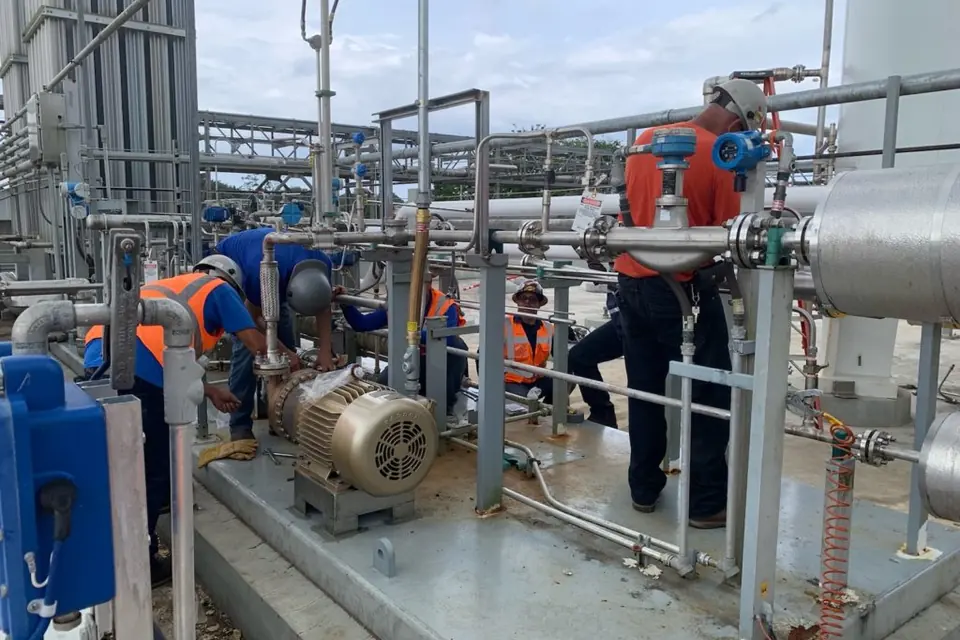 Crew installing a pump skid on site